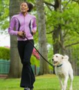 A woman running with a dog