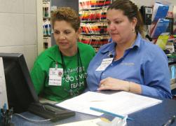 Veterinary professionals at a computer