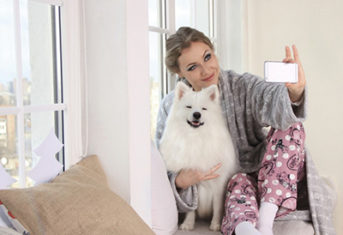 A woman taking a selfie with a dog