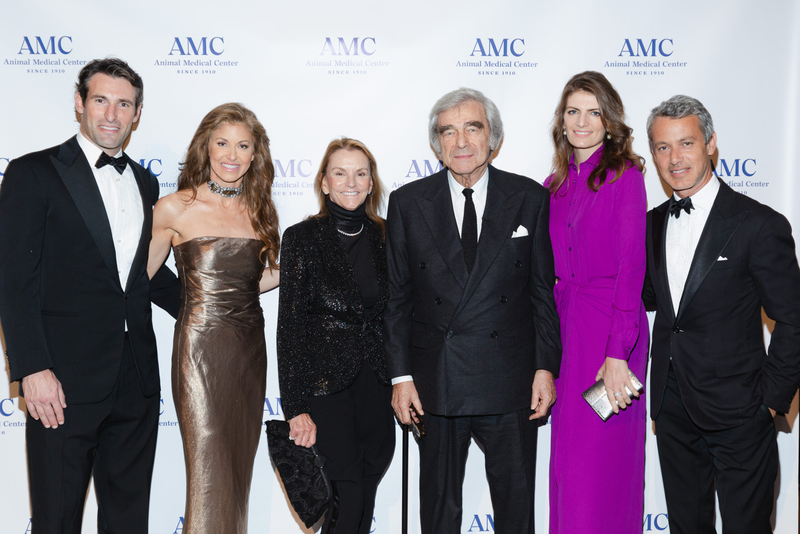 Dylan Lauren poses in front of an AMC backdrop with her family