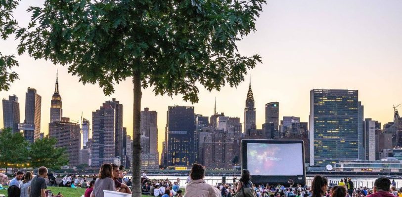 A crowd wathcing a movie outside