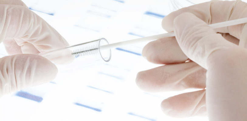 Researcher putting sample of DNA into a test tube