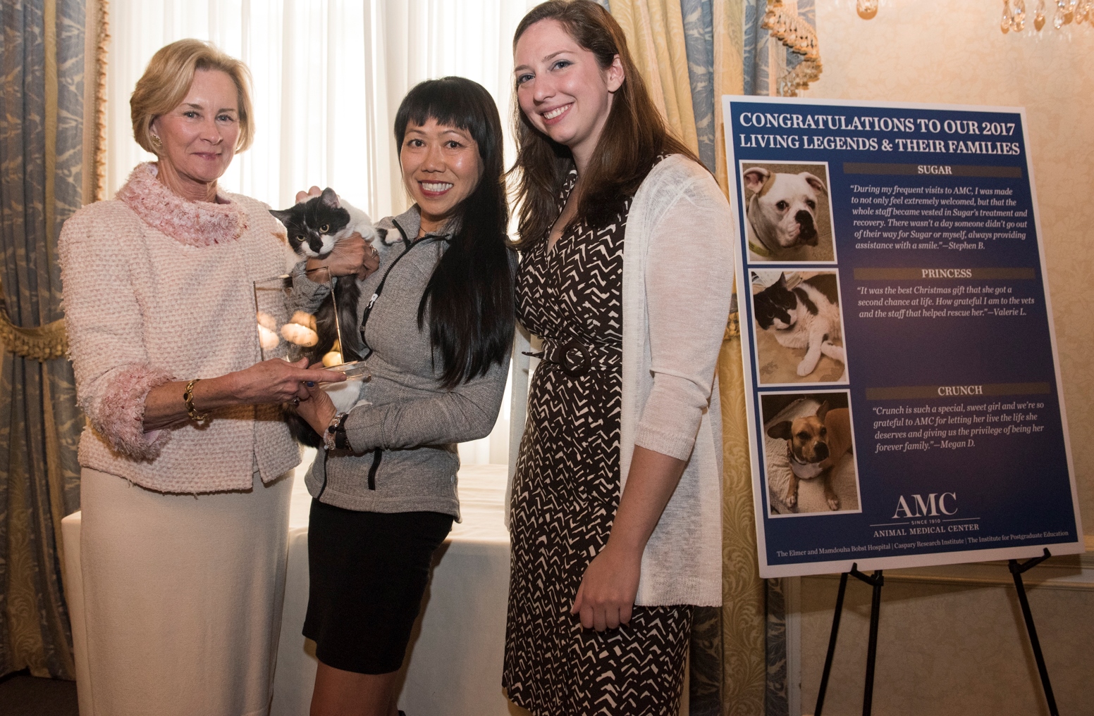 A woman and her cat are presented an award at AMC's Living Legends luncheon