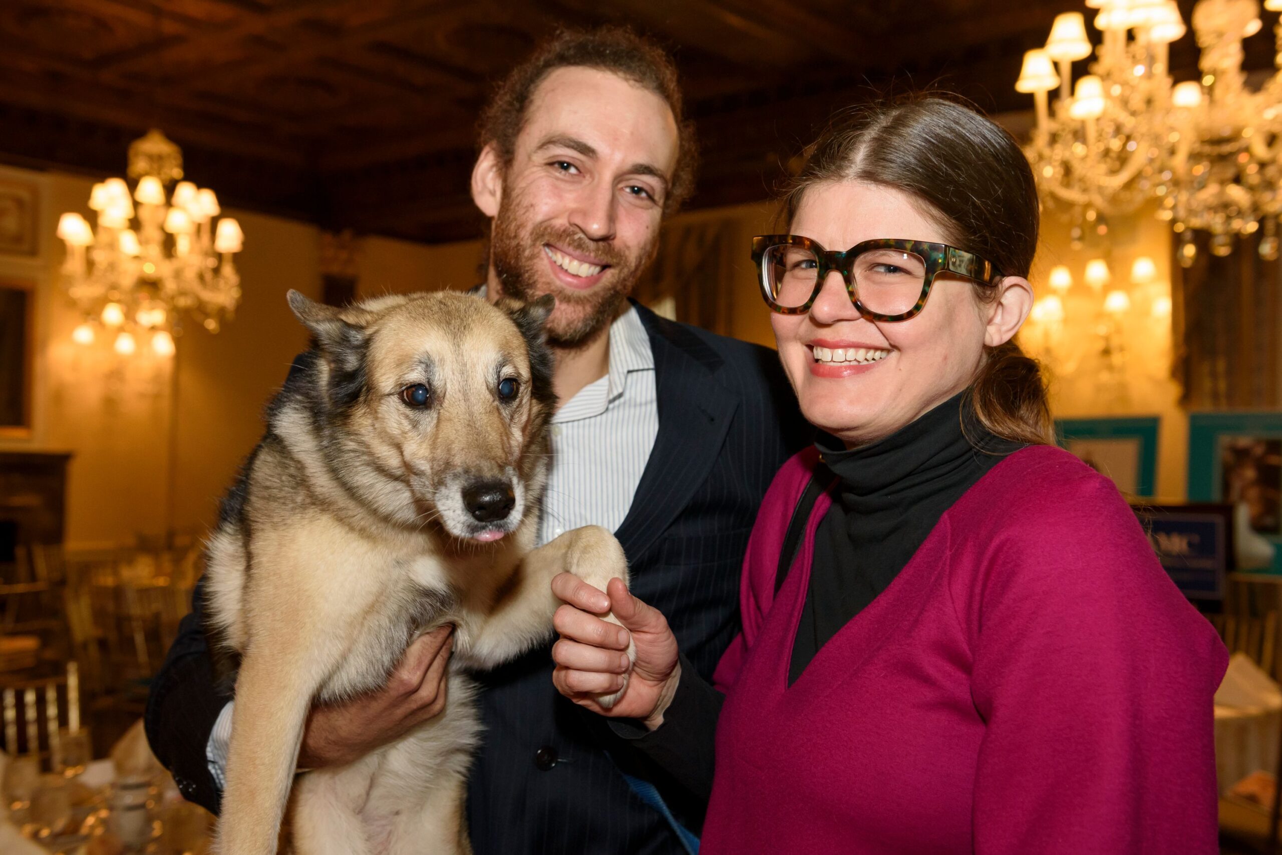 Elsa's owners holding her up for a photo at AMC's event