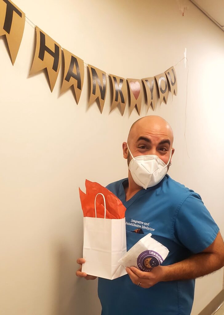 A veterinary assistant with a gift bag
