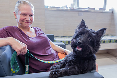 Woman smiles with her dog