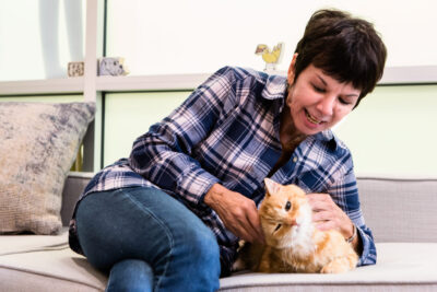 A woman with a cat on a couch