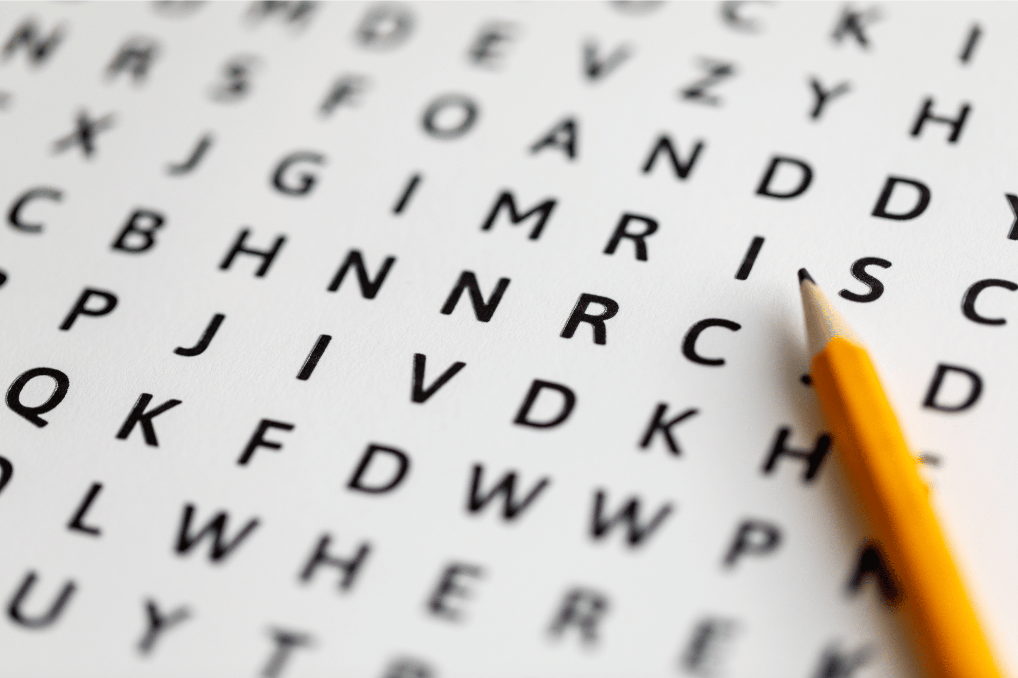 Pencil lying on top of word search puzzle