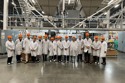 A group of veterinarians touring a pet food manufacturing plant