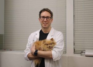 Dr. Carl Toborowsky with a staff dog.