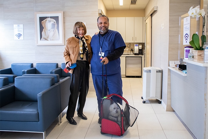 Rahen, Lobby Facilitator at AMC, helps a client and patient after an appointment.