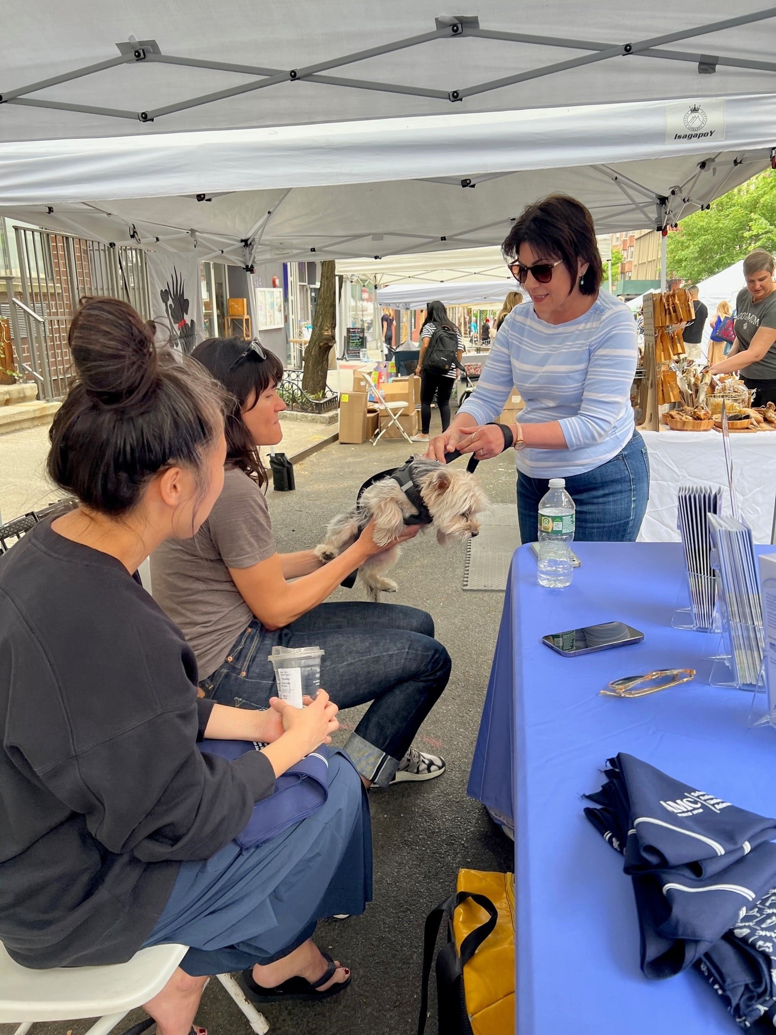 Dr. Heather Brausa and Dr. Christine Choe examining a dog at the Muddy Paws Block Party.